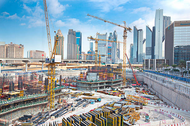 Construction site in Dubai with cranes and skyscrapers, illustrating the bustling development scene.